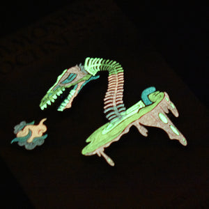 Lochness Monster Limited Edition Pin Sets - Soft Enamel with Epoxy - Collect Before They Disappear - 3-inch Size - Backstamp and Laser Numbering - Includes Matching Vinyl Sticker - Various Designs and Metal Plating - Full Glow, Glitter, and Specialty Options - Order Now